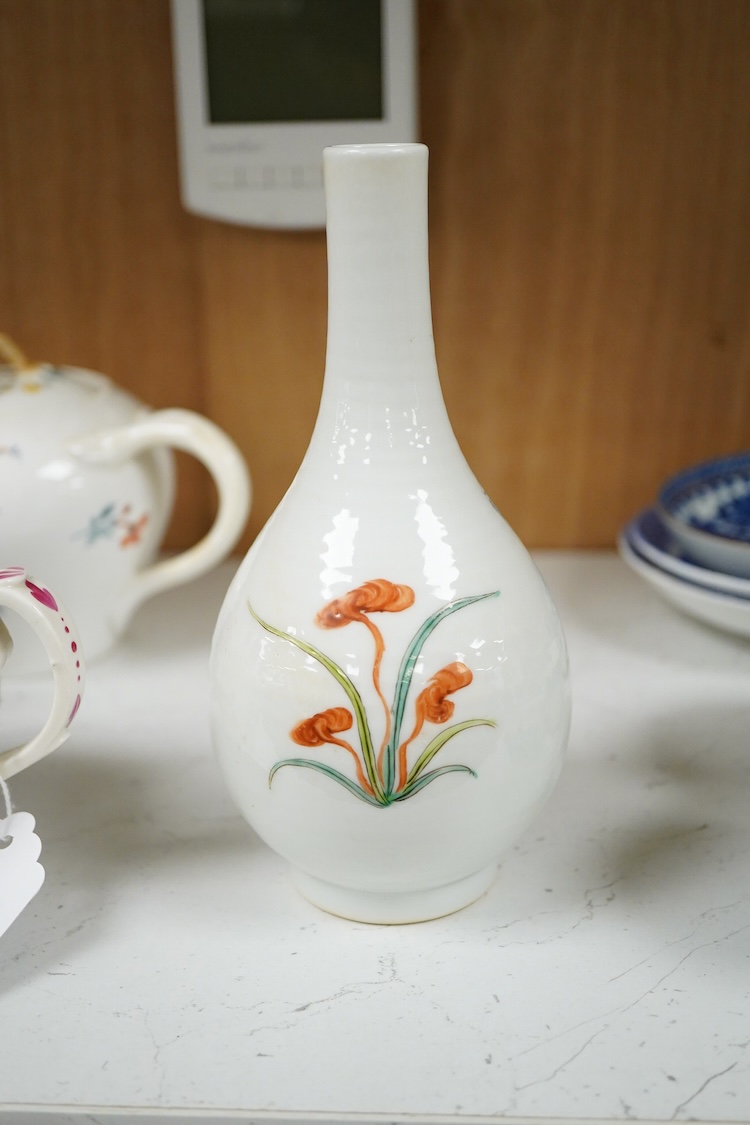 A Chinese famille rose bottle vase decorated with a figure, 17cm high